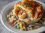 Golden seafood pot pie with creamy filling and flaky crust, rich and comforting.