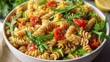 Colorful lemon Dijon pasta salad with fresh vegetables in a bowl.