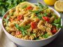 Colorful lemon Dijon pasta salad with fresh vegetables in a bowl.
