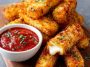 Crispy mozzarella sticks with marinara dipping sauce on a plate