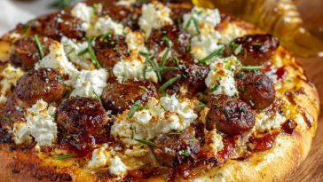 Crispy pizza topped with sausage, ricotta cheese, melted cheese, and drizzled with hot honey.