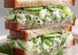Fresh cucumber salad sandwiches with cream cheese and herbs on a plate.