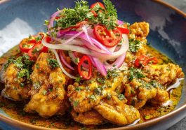 Tender chicken in creamy spicy aji amarillo sauce, a vibrant Peruvian-inspired dish.