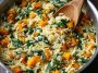 A warm bowl of creamy orzo pasta mixed with roasted butternut squash cubes and fresh spinach, garnished with Parmesan cheese and herbs.