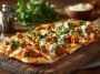 Soft flatbread topped with creamy butter chicken in a rich spiced sauce.