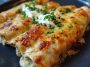 Creamy white chicken enchiladas made with rotisserie chicken, rolled in tortillas and topped with a rich white sauce and melted cheese.