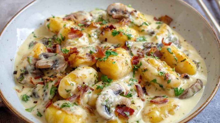 Millionaire gnocchi in creamy Parmesan sauce served in a skillet