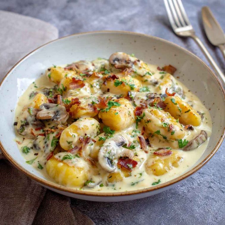 Millionaire gnocchi in creamy Parmesan sauce served in a skillet