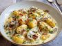 Millionaire gnocchi in creamy Parmesan sauce served in a skillet