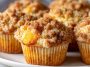 Soft peach cobbler muffins topped with a buttery crumb topping and filled with juicy peach pieces.