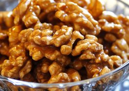 Crunchy caramel-coated walnuts glistening with a golden sugary glaze.