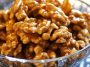Crunchy caramel-coated walnuts glistening with a golden sugary glaze.