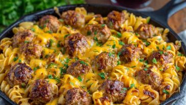BBQ ranch meatball and cheddar pasta skillet topped with melted cheese