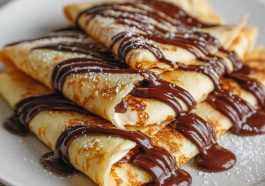 Thin crepes filled with melted chocolate, folded and topped with powdered sugar.