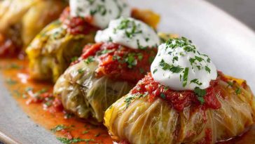 Tender cabbage rolls stuffed with a flavorful vegetarian filling of rice, vegetables, and herbs, baked in a rich tomato sauce.