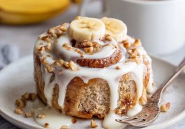 Soft banana bread cinnamon rolls swirled with cinnamon sugar and topped with creamy cream cheese frosting.