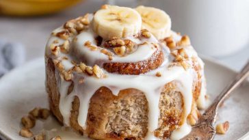 Soft banana bread cinnamon rolls swirled with cinnamon sugar and topped with creamy cream cheese frosting.
