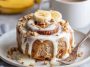 Soft banana bread cinnamon rolls swirled with cinnamon sugar and topped with creamy cream cheese frosting.