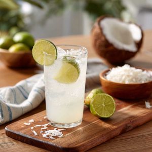 Coconut lime refresher drink with ice, lime slices, and a creamy tropical base.