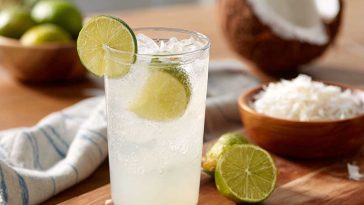 Coconut lime refresher drink with ice, lime slices, and a creamy tropical base.