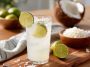 Coconut lime refresher drink with ice, lime slices, and a creamy tropical base.