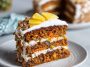 Moist carrot pineapple cake topped with creamy frosting and bits of crushed pineapple.