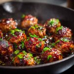 Juicy meatballs coated in a sticky hoisin glaze with a glossy finish.
