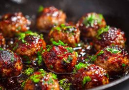 Juicy meatballs coated in a sticky hoisin glaze with a glossy finish.
