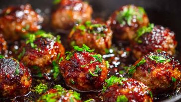 Juicy meatballs coated in a sticky hoisin glaze with a glossy finish.