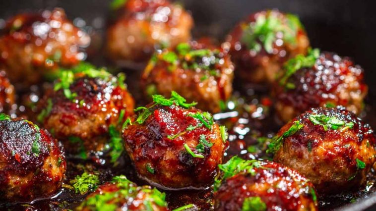 Juicy meatballs coated in a sticky hoisin glaze with a glossy finish.