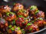 Juicy meatballs coated in a sticky hoisin glaze with a glossy finish.