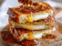 Hot honey grilled cheese sandwich with melted cheese and a drizzle of spicy honey between crispy golden bread.