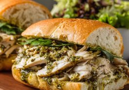 Toasted chicken pesto sandwich with juicy chicken, basil pesto, and melted cheese.