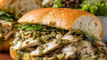 Toasted chicken pesto sandwich with juicy chicken, basil pesto, and melted cheese.