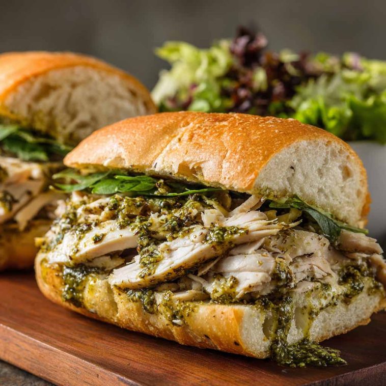 Toasted chicken pesto sandwich with juicy chicken, basil pesto, and melted cheese.