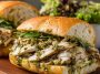 Toasted chicken pesto sandwich with juicy chicken, basil pesto, and melted cheese.