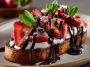 Slices of toasted baguette topped with melted chocolate, fresh strawberries, and a drizzle of chocolate sauce, arranged on a serving platter.