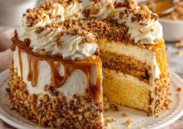 Butterscotch crunch cake layered with creamy frosting and topped with crunchy butterscotch bits and caramel drizzle.