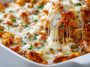 Dump-and-bake chicken parmesan casserole topped with melted cheese and herbs