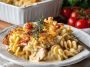 A creamy Cajun chicken pasta bake topped with melted cheese, baked until golden, and garnished with fresh parsley in a casserole dish.