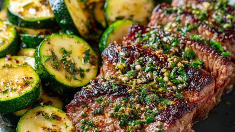 Garlic butter steak with sautéed zucchini, cooked to perfection with a rich, glossy sauce.