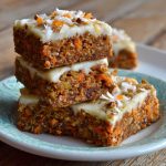 Healthy Easter carrot cake bars topped with light cream cheese frosting and festive sprinkles.