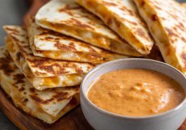 Creamy taco-style quesadilla sauce with a smooth texture and a hint of spice served in a small bowl.
