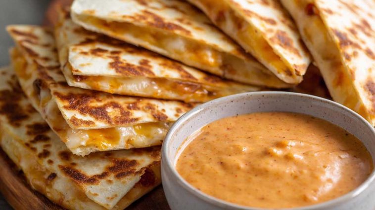 Creamy taco-style quesadilla sauce with a smooth texture and a hint of spice served in a small bowl.