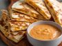Creamy taco-style quesadilla sauce with a smooth texture and a hint of spice served in a small bowl.