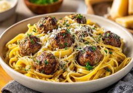 Parmesan linguine topped with juicy garlic butter meatballs in a rich savory sauce.