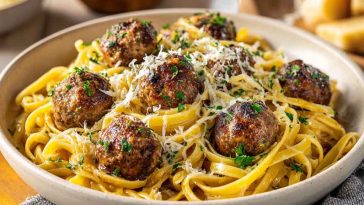 Parmesan linguine topped with juicy garlic butter meatballs in a rich savory sauce.