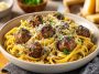 Parmesan linguine topped with juicy garlic butter meatballs in a rich savory sauce.