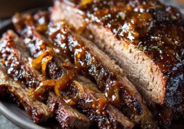 Slow cooker brisket cooked until tender, sliced and served with rich gravy and herbs.
