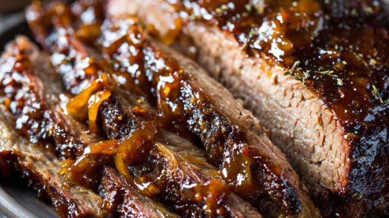 Slow cooker brisket cooked until tender, sliced and served with rich gravy and herbs.